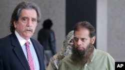 FILE - Shafi Khan, right, and Zarine Khan, parents of Mohammed Hamzah Khan, meet with the family's attorney, Thomas Dirkin, left, before Mohammed's detention hearing in federal court in Chicago, Oct. 9, 2014.