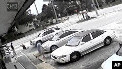 FILE - In this image taken from surveillance video released by the Pinellas County Sheriff's Office, Markeis McGlockton, far left, is shot by Michael Drejka during an altercation in the parking lot of a convenience store in Clearwater, Florida, July 19, 2018. 