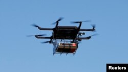 FILE - A drone demonstrates delivery capabilities from the top of a UPS truck during testing in Lithia, Florida, U.S.